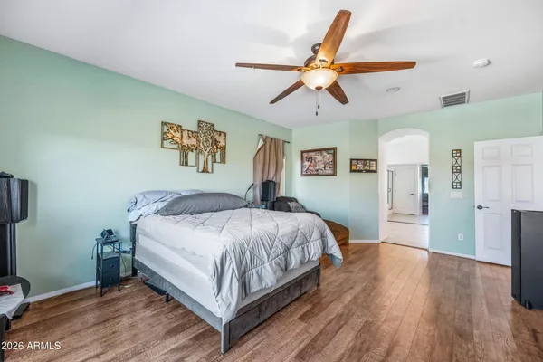 a large white kitchen with a sink and a large mirror of a living room