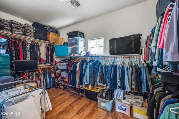 a view of a hallway with wooden floor and closet area