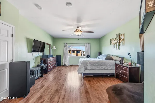 a bedroom with a bed and a ceiling fan