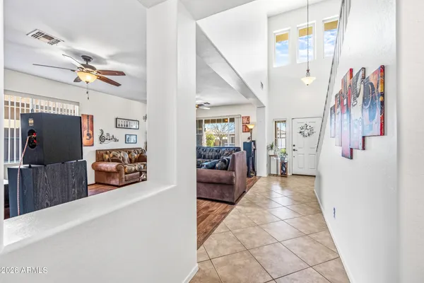 a view of a hallway with wooden floor and furniture