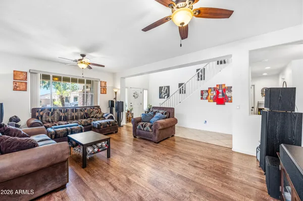 a living room with furniture and a wooden floor