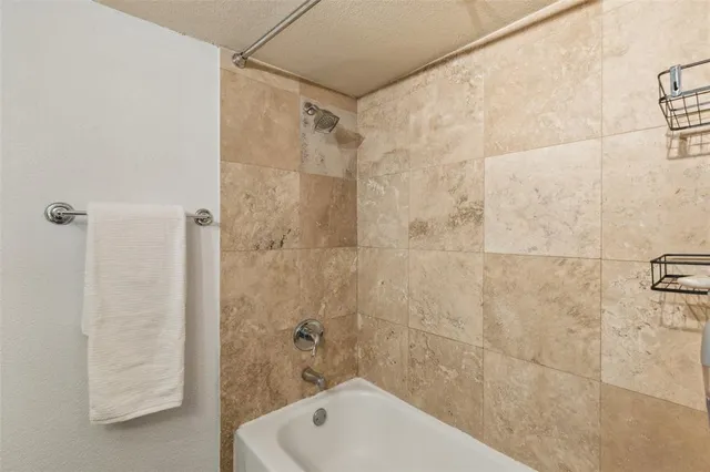 a bathroom with a shower and a bathtub