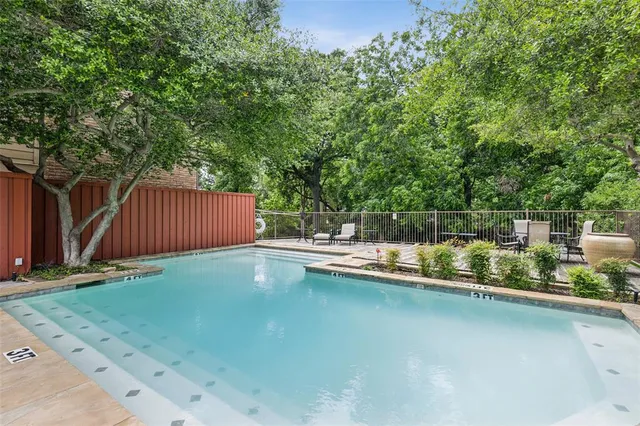 a view of a backyard with swimming pool