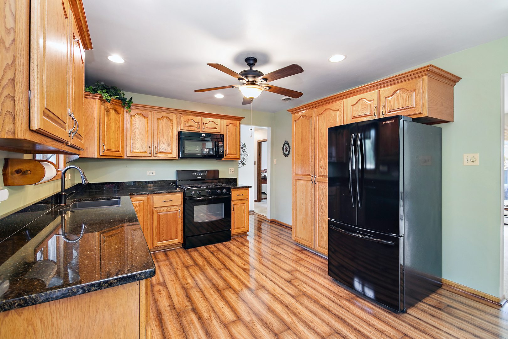 15124 Chestnut Lane Oak Forest, IL 60452 - Photo 6 of 18 a kitchen with a refrigerator a stove top oven a sink and dishwasher