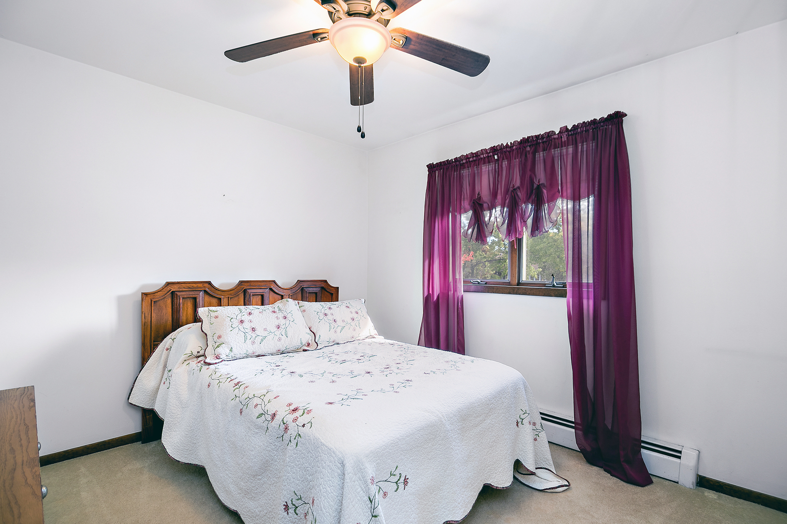 15124 Chestnut Lane Oak Forest, IL 60452 - Photo 8 of 18 a bedroom with a large bed and a chandelier