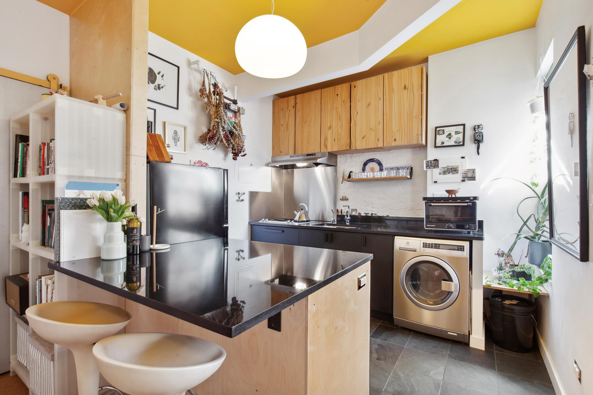 30 Macombs Place, Unit 62 Manhattan, NY 10039 - Photo 3 of 7 a kitchen with stainless steel appliances granite countertop a sink a stove and a wooden floors