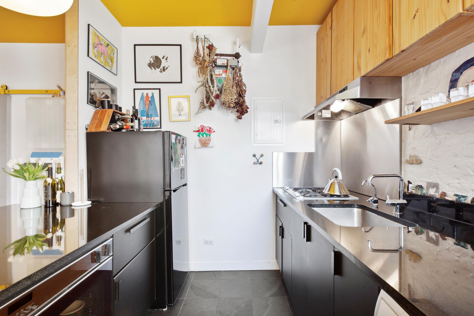30 Macombs Place, Unit 62 Manhattan, NY 10039 - Photo 4 of 7 a kitchen with stainless steel appliances a sink a stove and a refrigerator