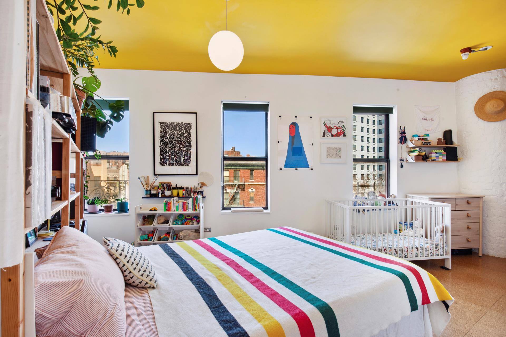 30 Macombs Place, Unit 62 Manhattan, NY 10039 - Photo 5 of 7 a bedroom with a bed and a chandelier