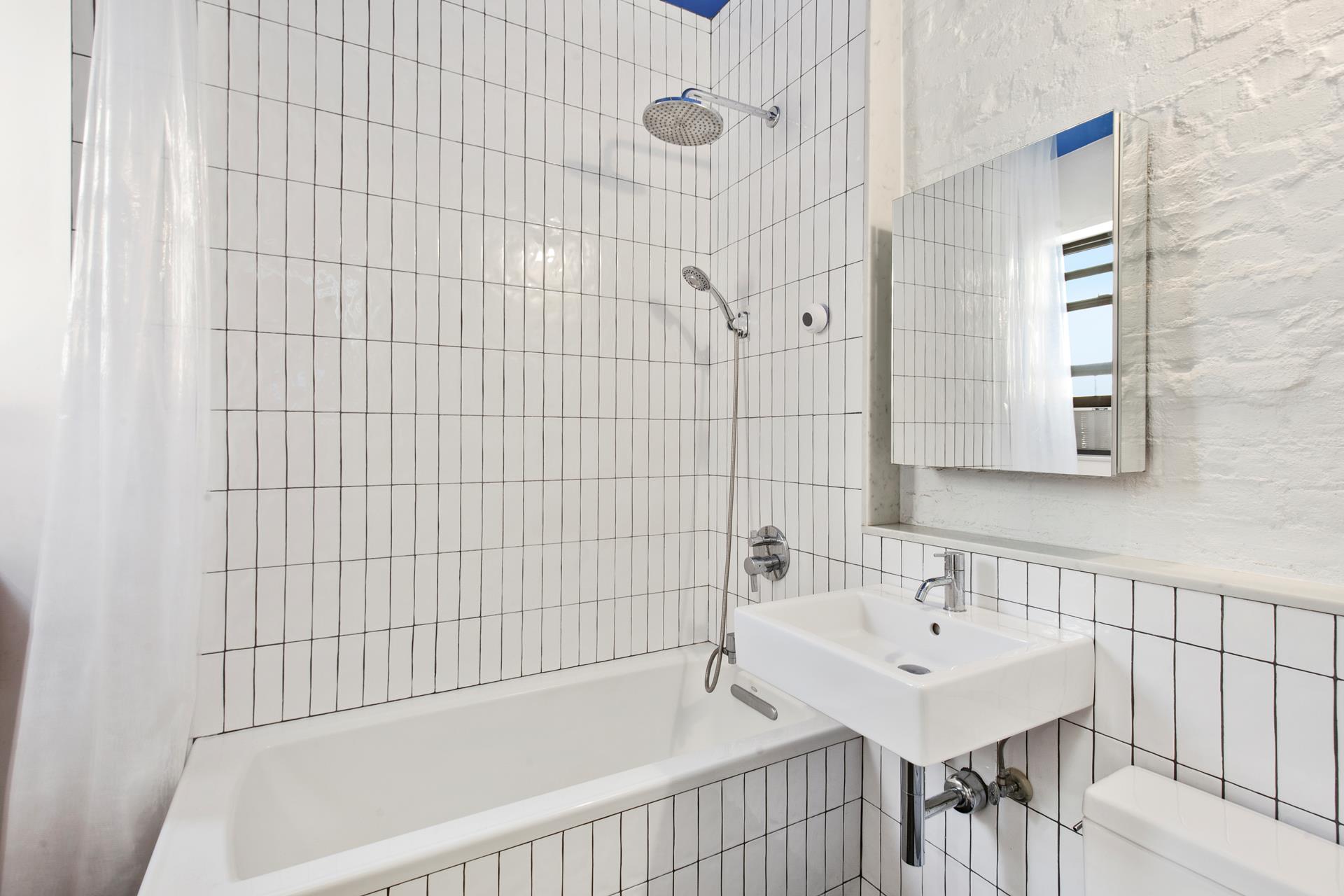 30 Macombs Place, Unit 62 Manhattan, NY 10039 - Photo 6 of 7 a bathroom with a bathtub and a sink