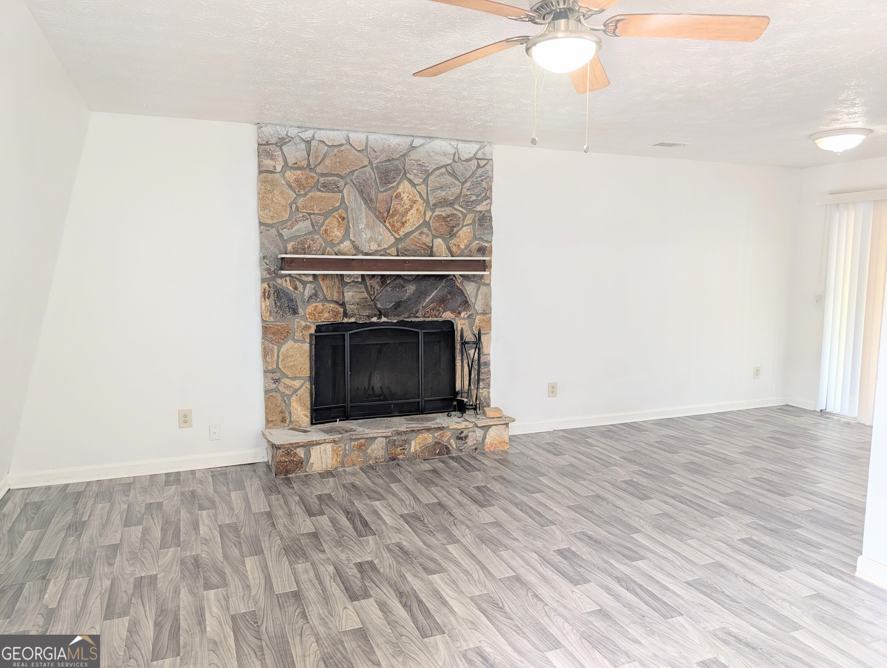 460 Rustwood Drive Athens, GA 30606 - Photo 2 of 7 an empty room with wooden floor a fireplace