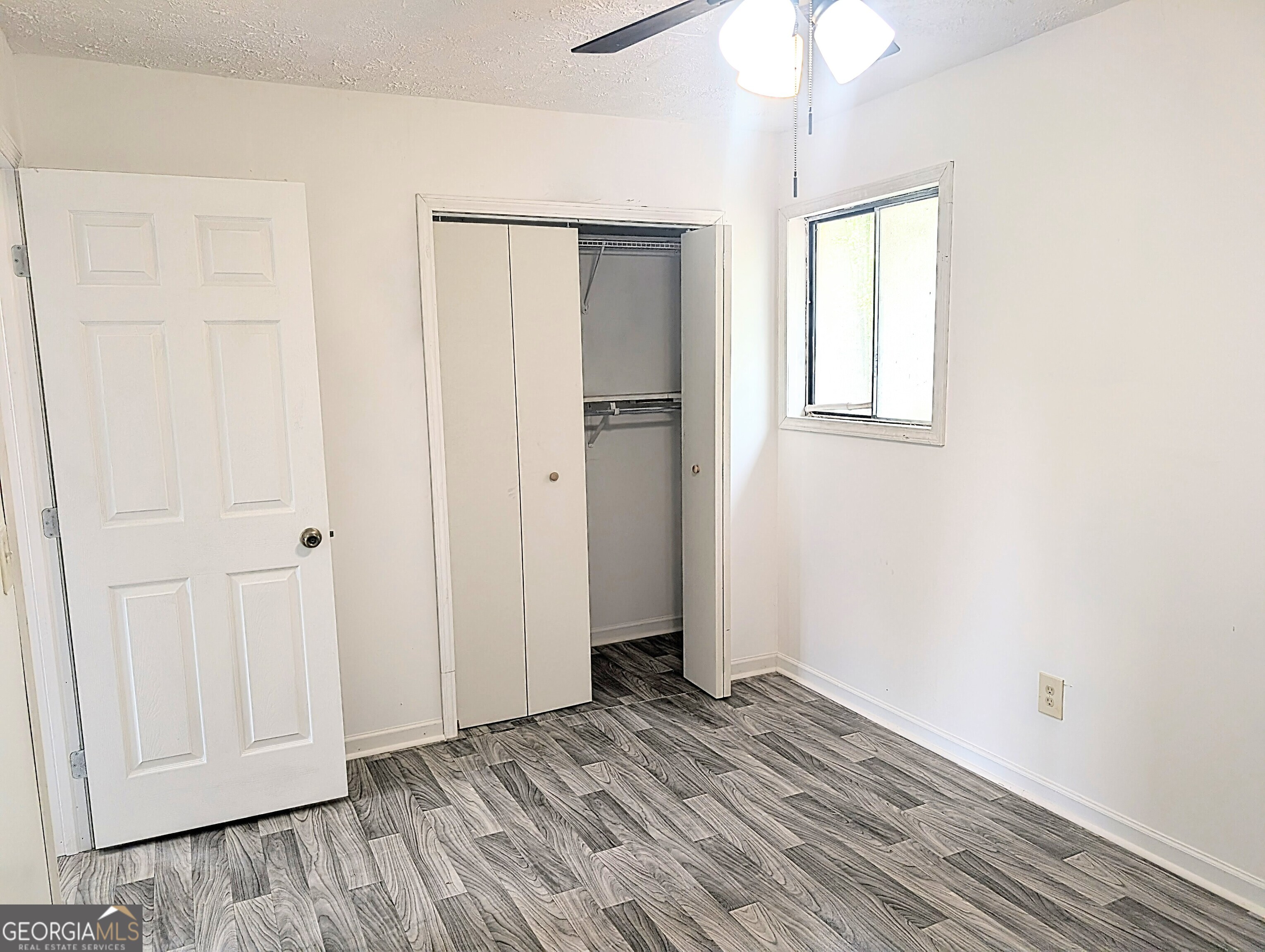 460 Rustwood Drive Athens, GA 30606 - Photo 7 of 7 an empty room with wooden floor cabinet and windows
