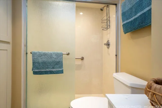 a bathroom with a toilet a sink and shower