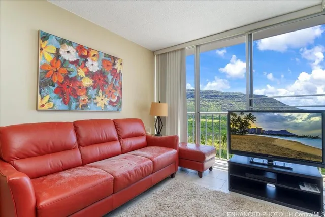 a blue couch sitting in front of a window with a projector screen
