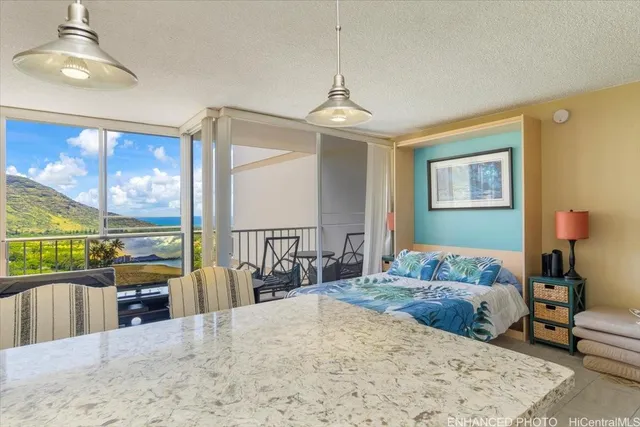 a bedroom with a bed a large window and furniture