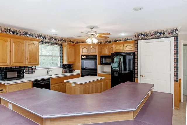 a kitchen with cabinets and window