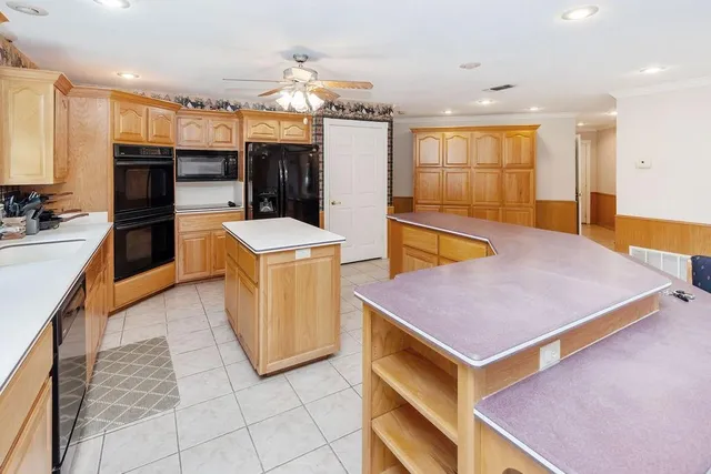 a kitchen with cabinets and refrigerator
