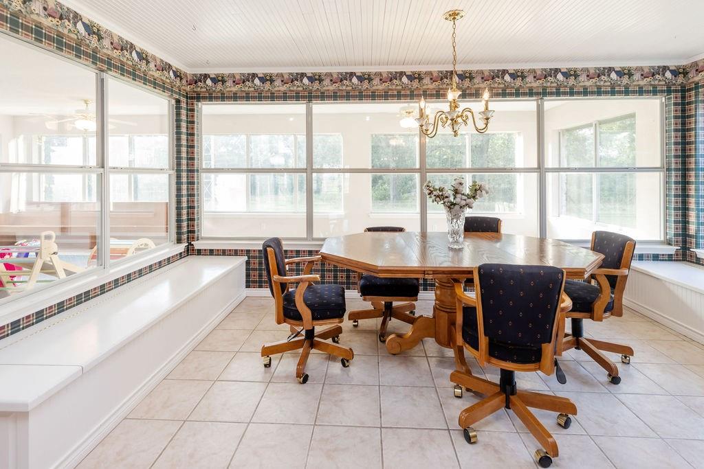 2290 County Road Honey Grove, TX 75446 - Photo 13 of 37 a dining room with furniture and a large window