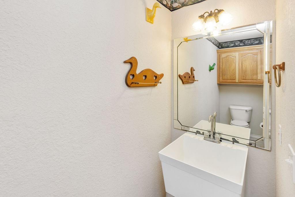 2290 County Road Honey Grove, TX 75446 - Photo 16 of 37 a bathroom with a sink and mirror