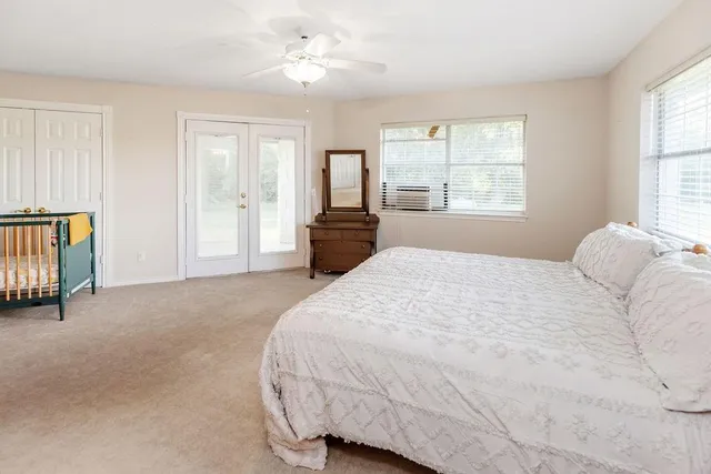 a spacious bedroom with a large bed and a window