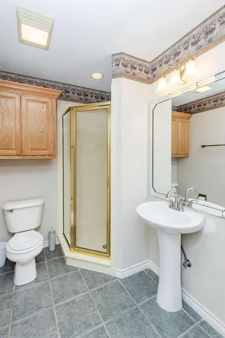 a bathroom with a sink toilet and shower