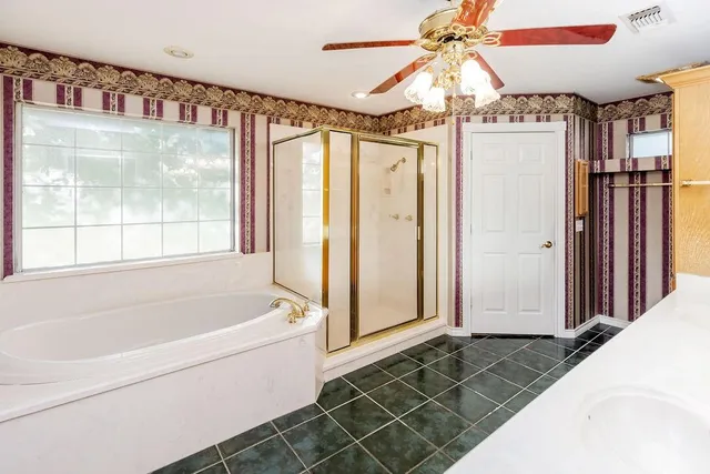 a bathroom with a bathtub and a shower