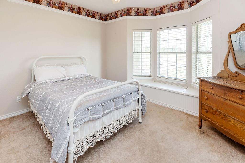 2290 County Road Honey Grove, TX 75446 - Photo 30 of 37 a bedroom with a bed and a window