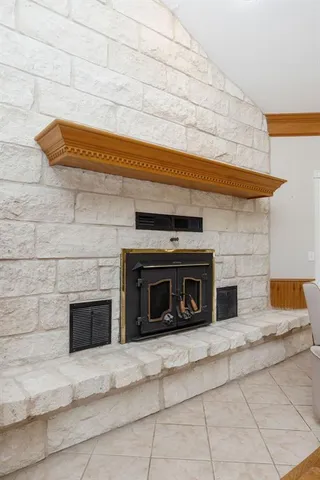 a bedroom with a bed and a fireplace