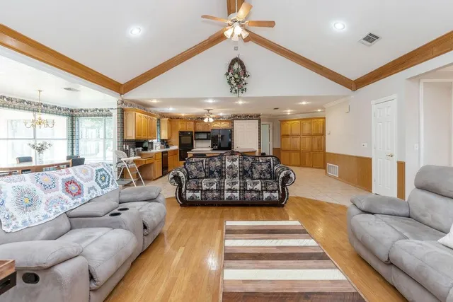 a living room with furniture ceiling fan and a rug