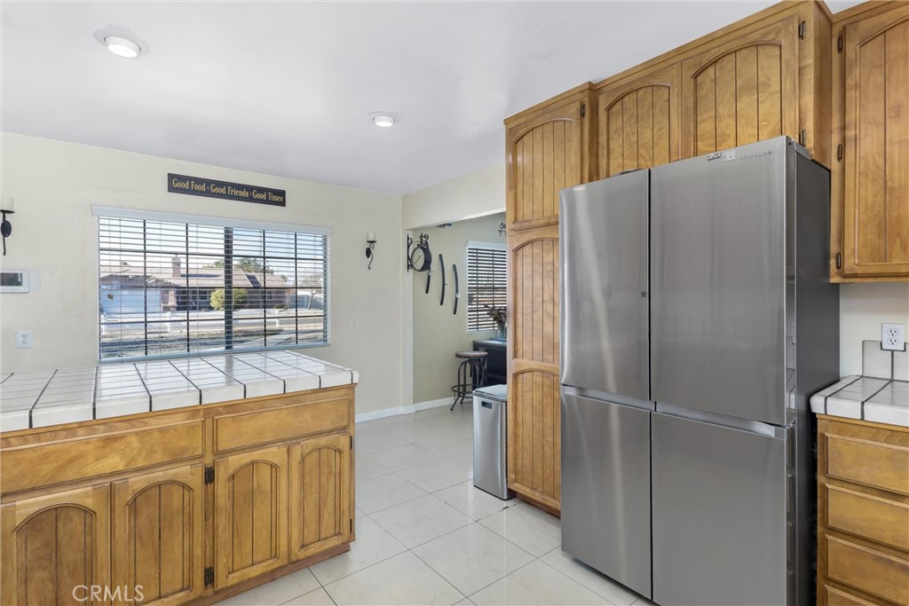 13447 Iroquois Road Apple Valley, CA 92308 - Photo 11 of 45 a kitchen with stainless steel appliances granite countertop a refrigerator and a sink