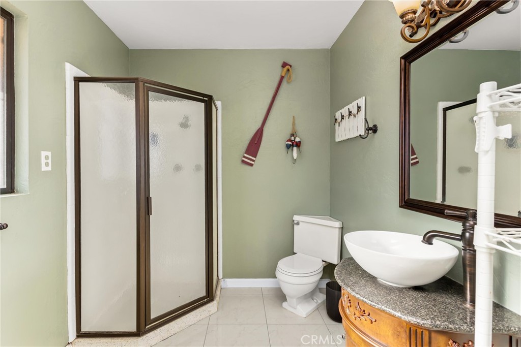 13447 Iroquois Road Apple Valley, CA 92308 - Photo 17 of 45 a bathroom with a granite countertop toilet and a sink