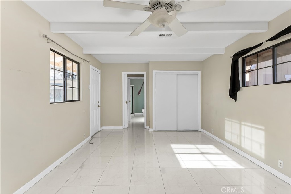 13447 Iroquois Road Apple Valley, CA 92308 - Photo 19 of 45 a view of an empty room with a window