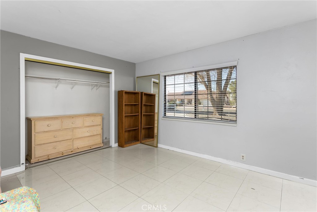 13447 Iroquois Road Apple Valley, CA 92308 - Photo 21 of 45 a view of an empty room with a window