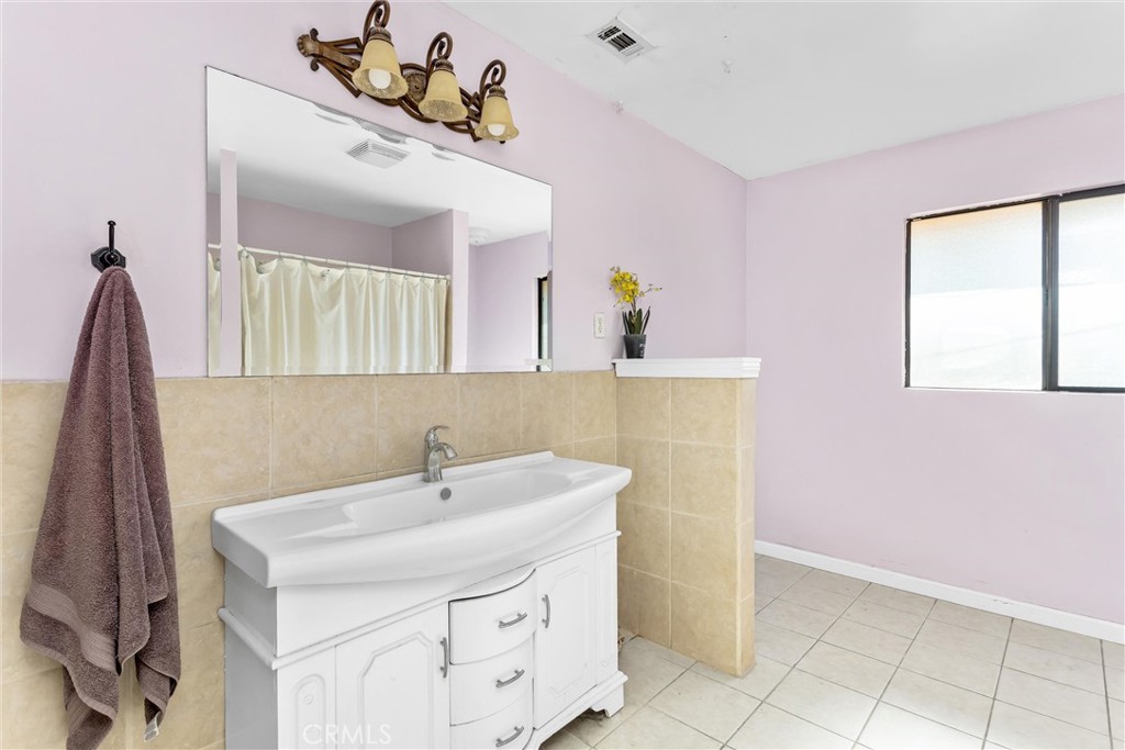 13447 Iroquois Road Apple Valley, CA 92308 - Photo 25 of 45 a bathroom with a sink and a mirror