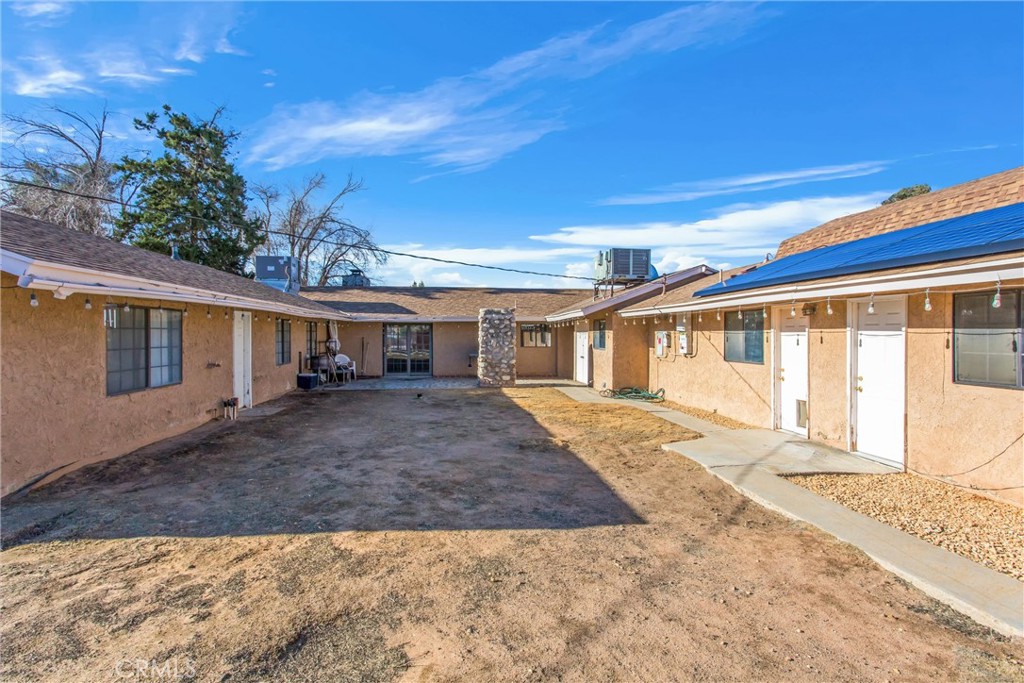 13447 Iroquois Road Apple Valley, CA 92308 - Photo 28 of 45 a front view of a house with a yard and garage