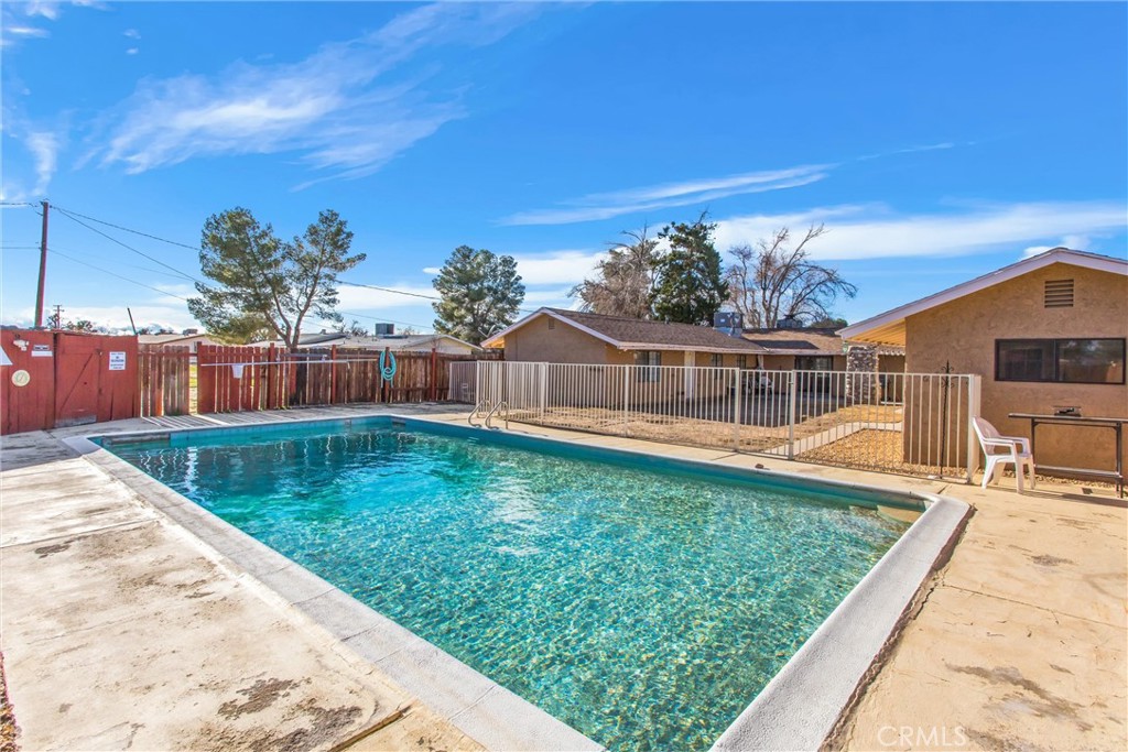 13447 Iroquois Road Apple Valley, CA 92308 - Photo 32 of 45 a view of a swimming pool with a patio