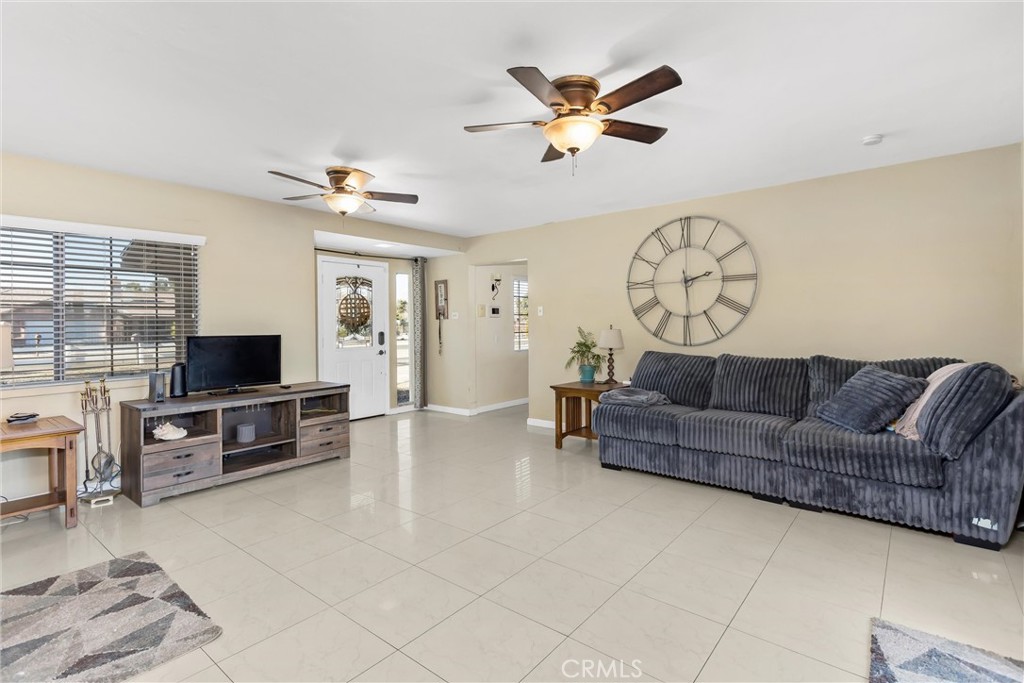 13447 Iroquois Road Apple Valley, CA 92308 - Photo 7 of 45 a living room with furniture and a flat screen tv