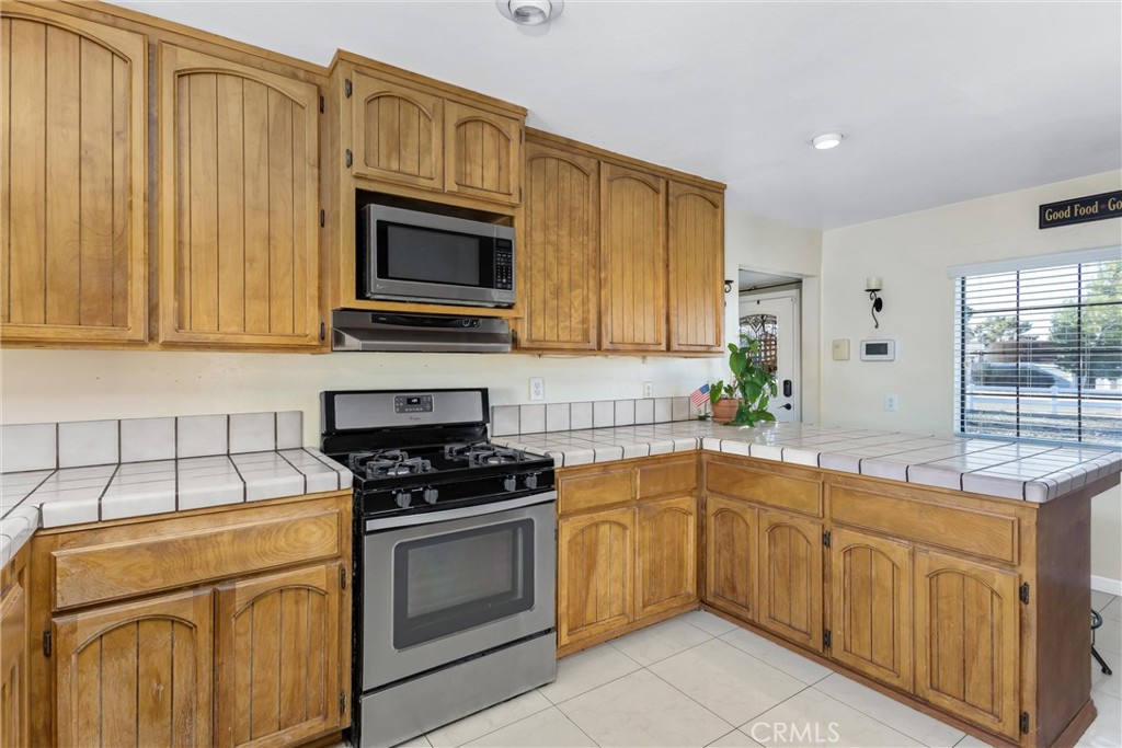 13447 Iroquois Road Apple Valley, CA 92308 - Photo 9 of 45 a kitchen with cabinets appliances and a sink