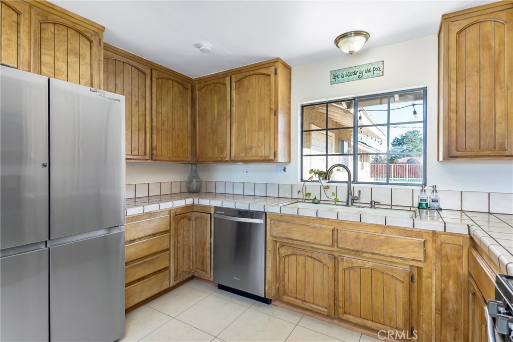 13447 Iroquois Road Apple Valley, CA 92308 - Photo 10 of 45 a kitchen with stainless steel appliances granite countertop a refrigerator and a sink