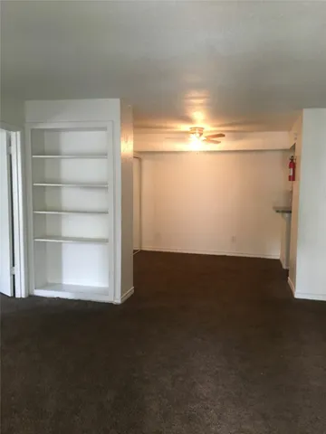 a kitchen with granite countertop white cabinets and a sink
