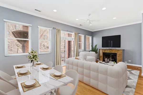 a living room with furniture a fireplace and a flat screen tv