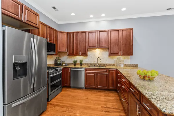 a kitchen with stainless steel appliances granite countertop a refrigerator stove and oven