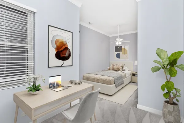 a bedroom with a bed and a potted plant