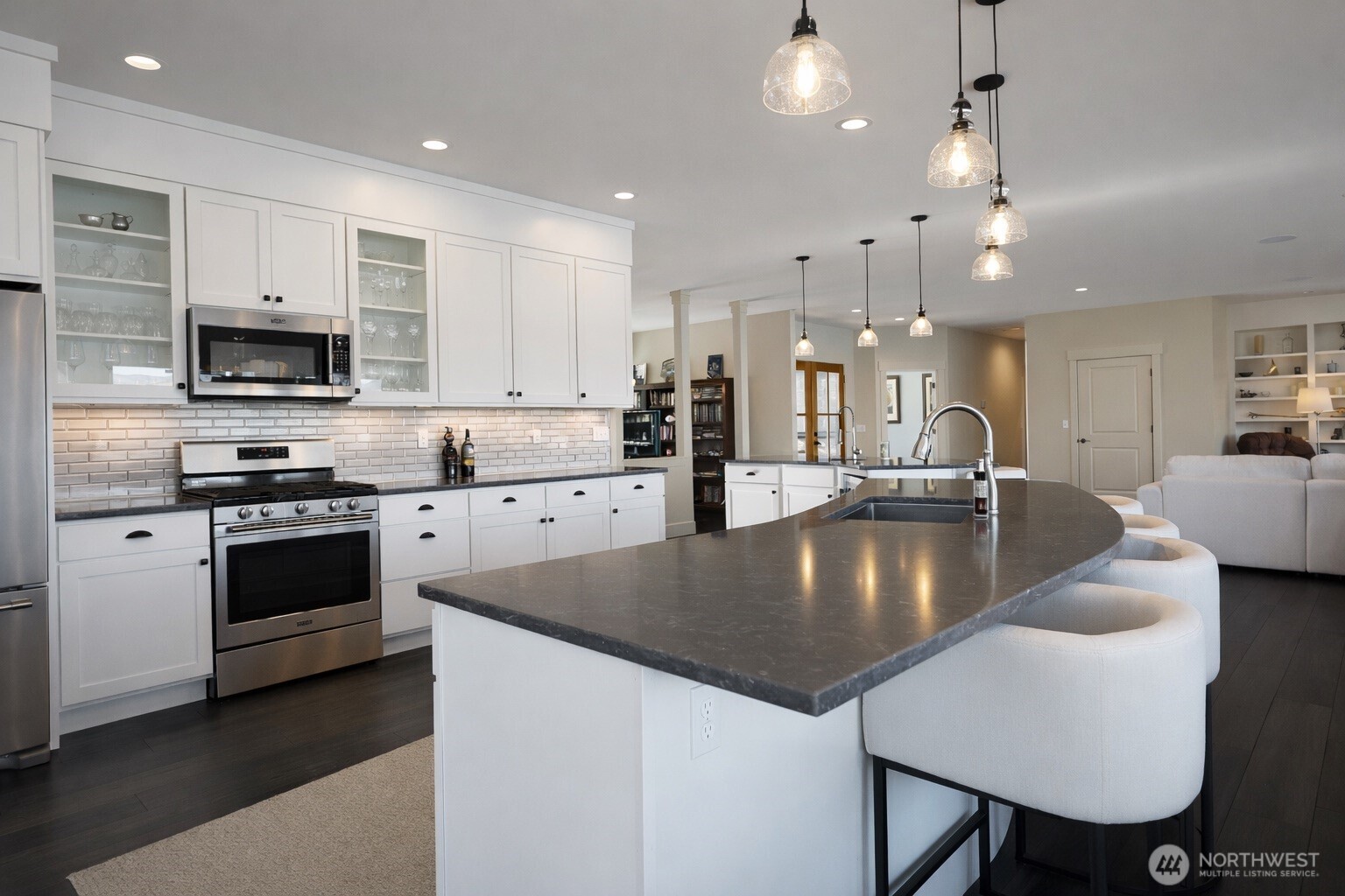 149 Clos Chevalle Road Chelan, WA 98816 - Photo 11 of 37 a large kitchen with kitchen island a stove a sink a table and chairs