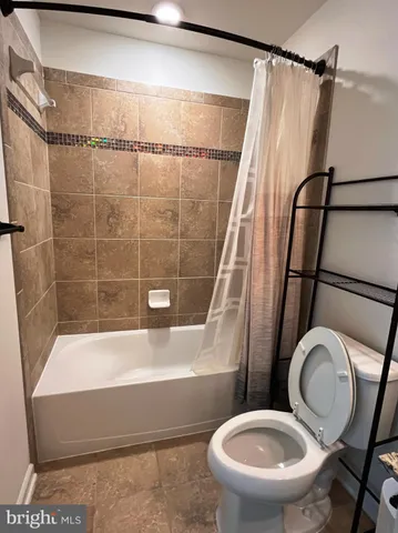a bathroom with a toilet and a tub