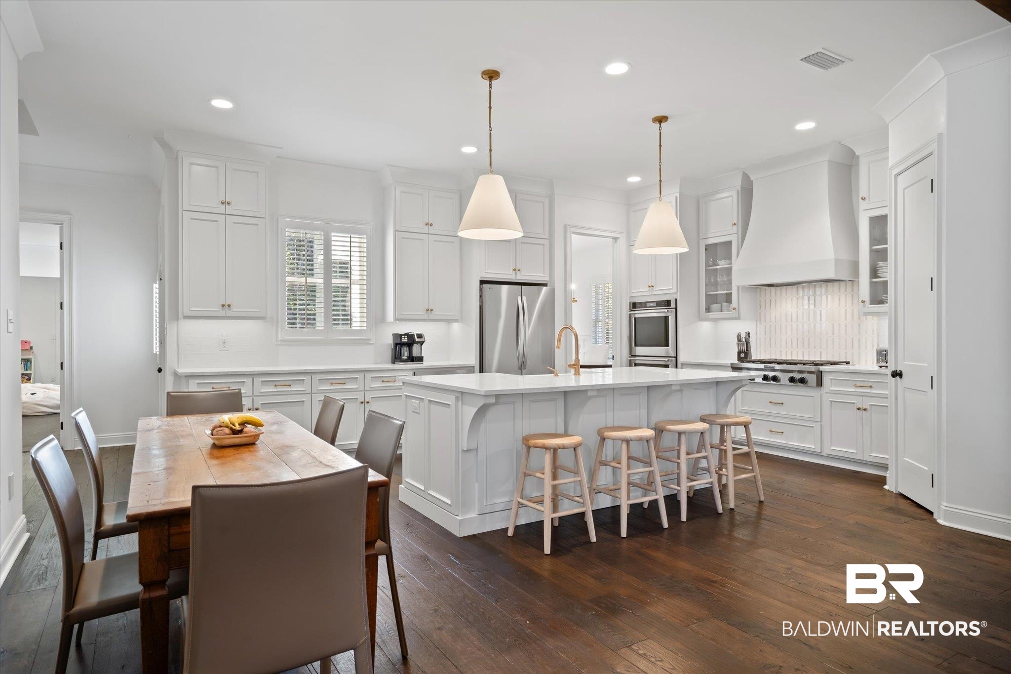3713 Old Shell Road Mobile, AL 36608 - Photo 10 of 52 Kitchen featuring custom range hood, stainless steel appliances, dark wood-type flooring, decorative light fixtures, and an island with sink