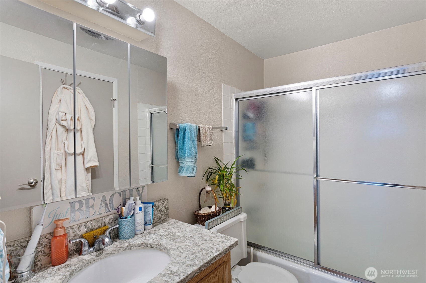 17301 Northeast 45th Street, Unit 87 Redmond, WA 98052 - Photo 11 of 20 a bathroom with a granite countertop shower sink vanity and toilet