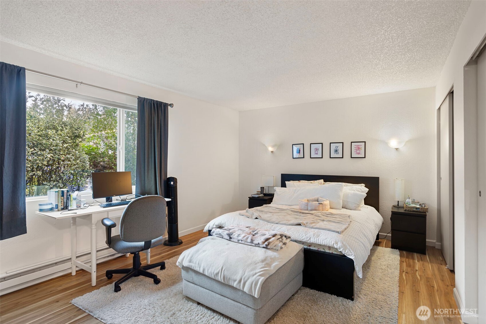 17301 Northeast 45th Street, Unit 87 Redmond, WA 98052 - Photo 12 of 20 a bedroom with a bed and a large window