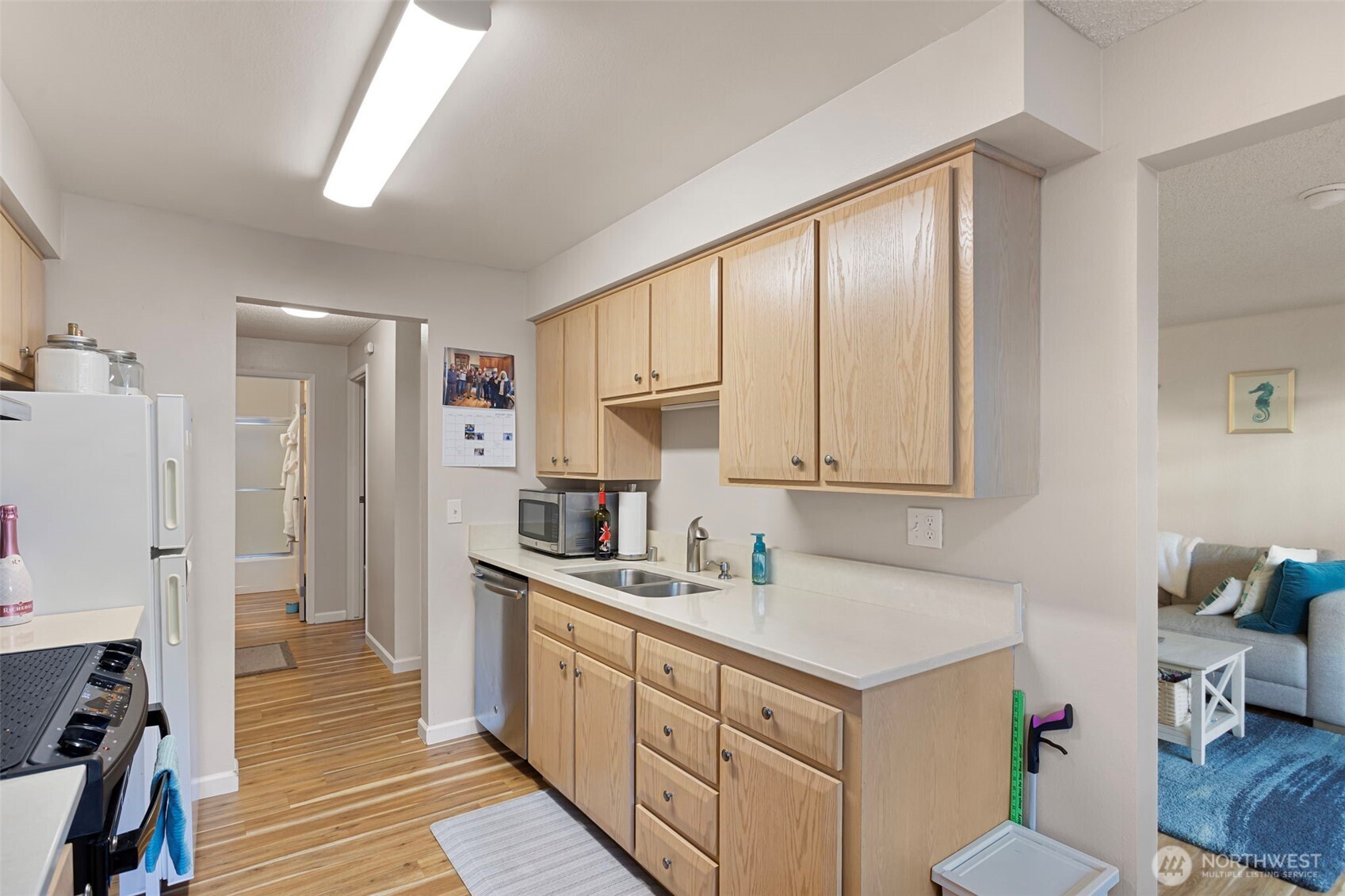 17301 Northeast 45th Street, Unit 87 Redmond, WA 98052 - Photo 9 of 20 a kitchen with a sink cabinets and wooden floor