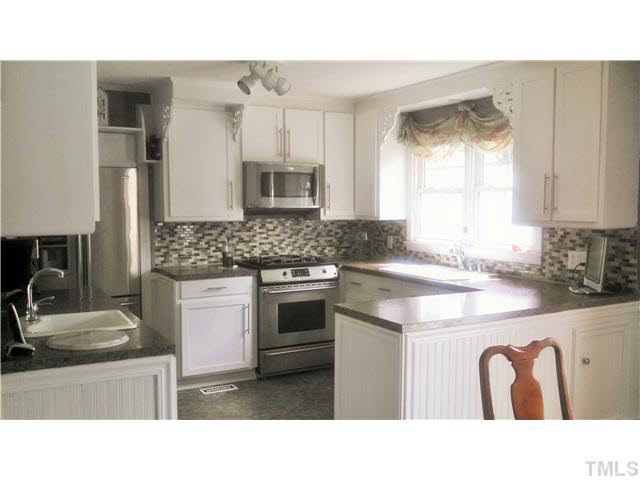 313 Pine Tree Road Oxford, NC 27565 - Photo 8 of 17 Kitchen completely redone with eat in dining room -- open light, appliances are stainless, oven is dual fuel stove with gas burners, microwave is convection plus! Sorry about the lighting with this picture!