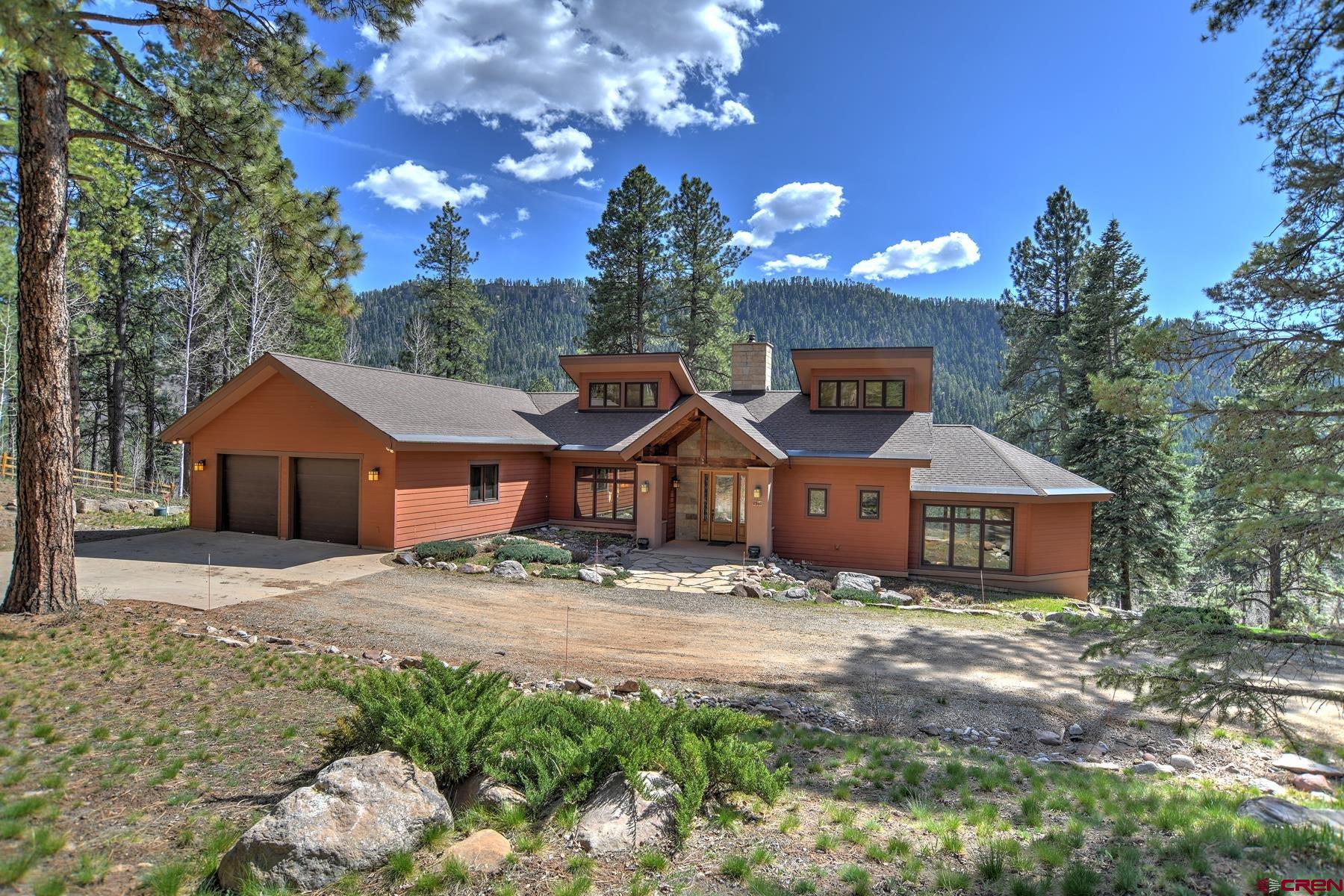 a front view of a house with a yard yard and garage